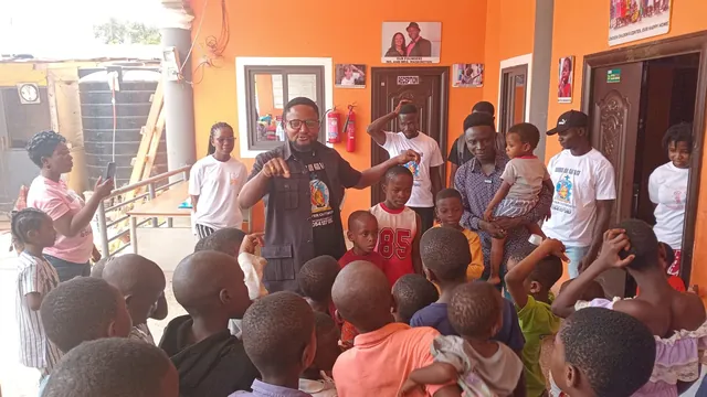 A team member talking with a crowd of excited children
