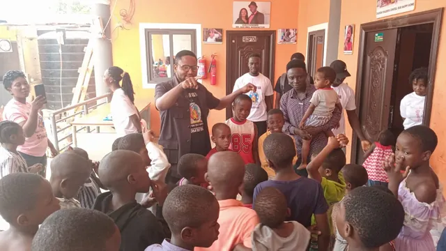 Children raising their hands as a team member talks with them